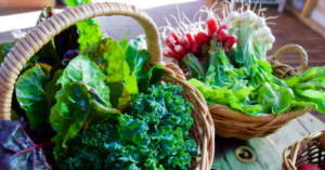 Baskets of green leafy vegetables on a table